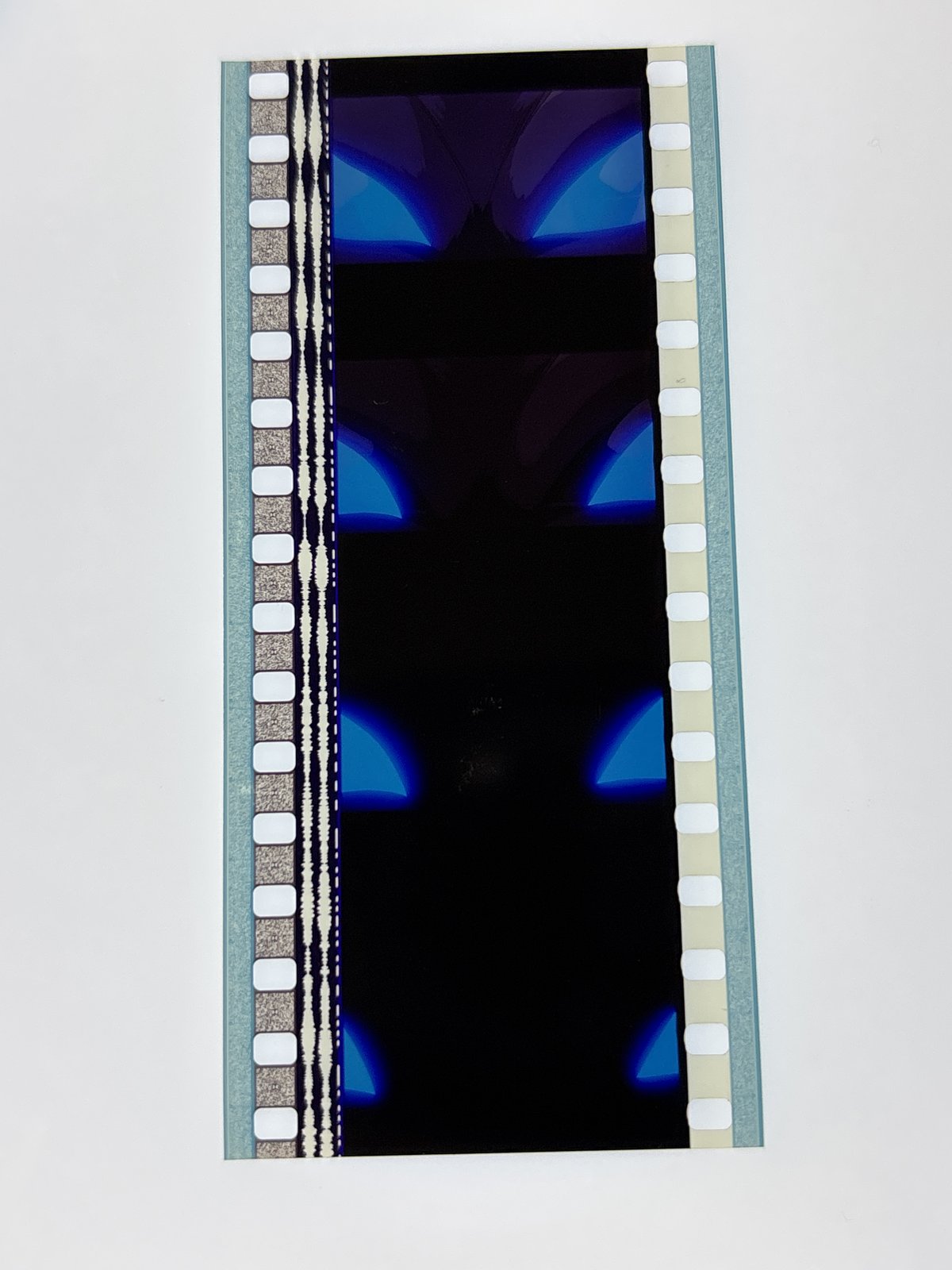 The film strip as photographed on the light panel at intake, before encapsulation