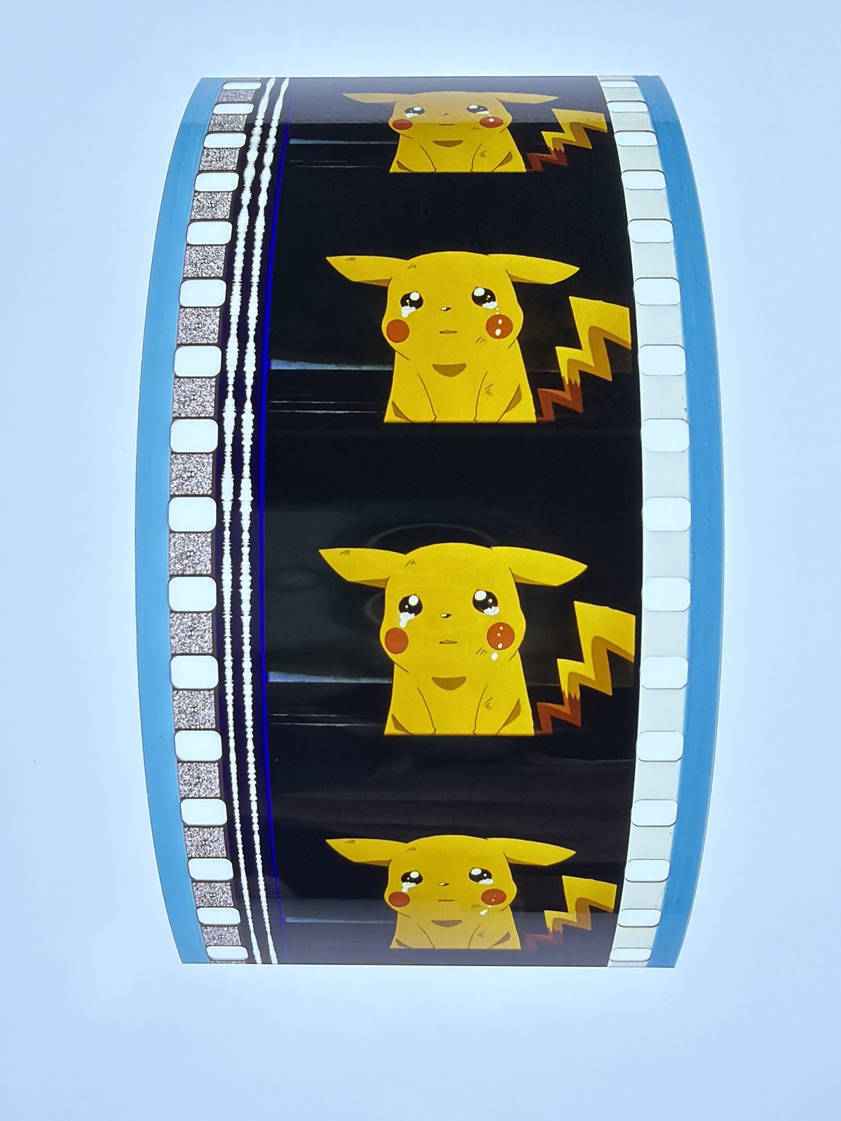 The film strip as photographed on the light panel at intake, before encapsulation