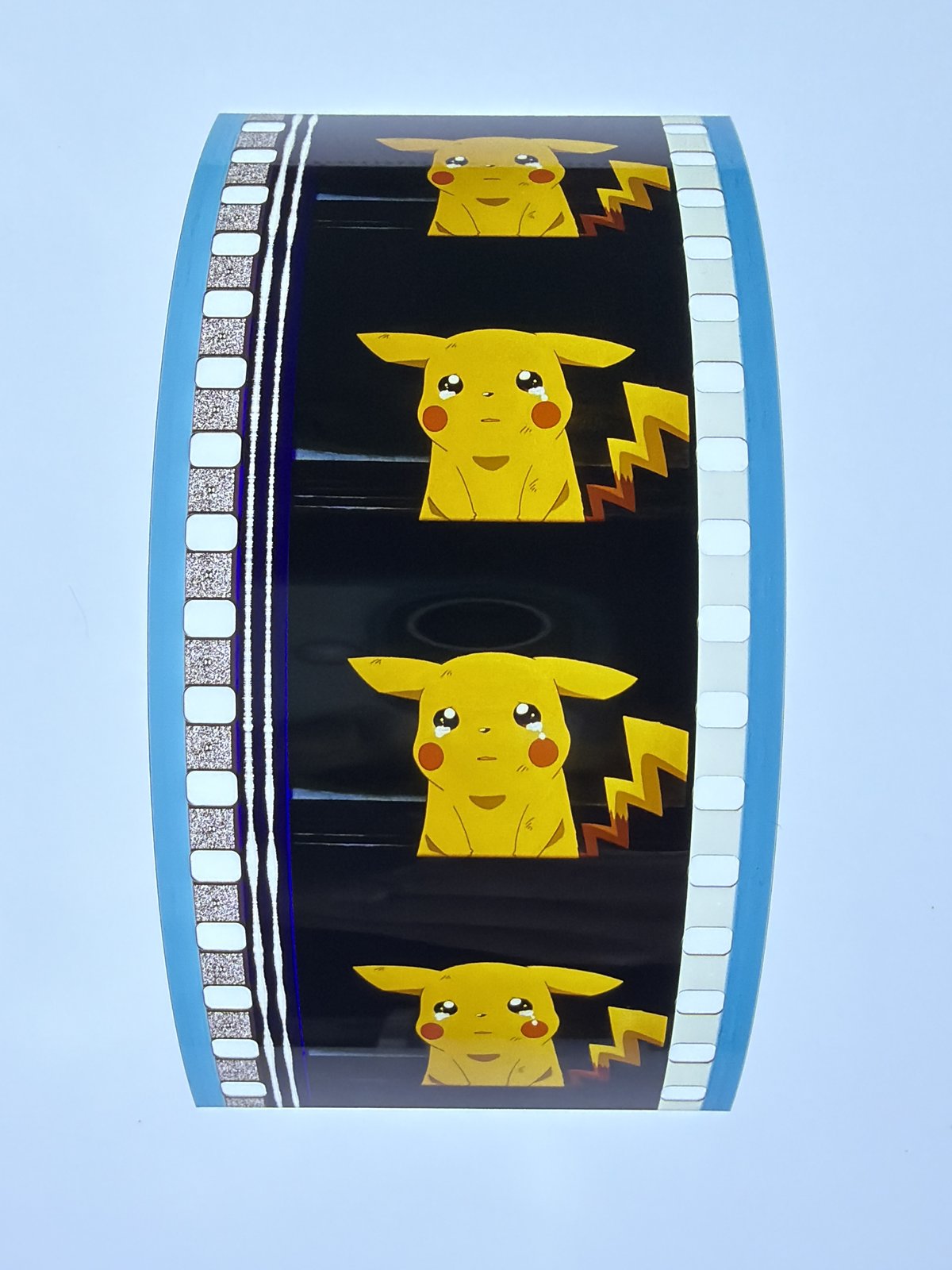 The film strip as photographed on the light panel at intake, before encapsulation