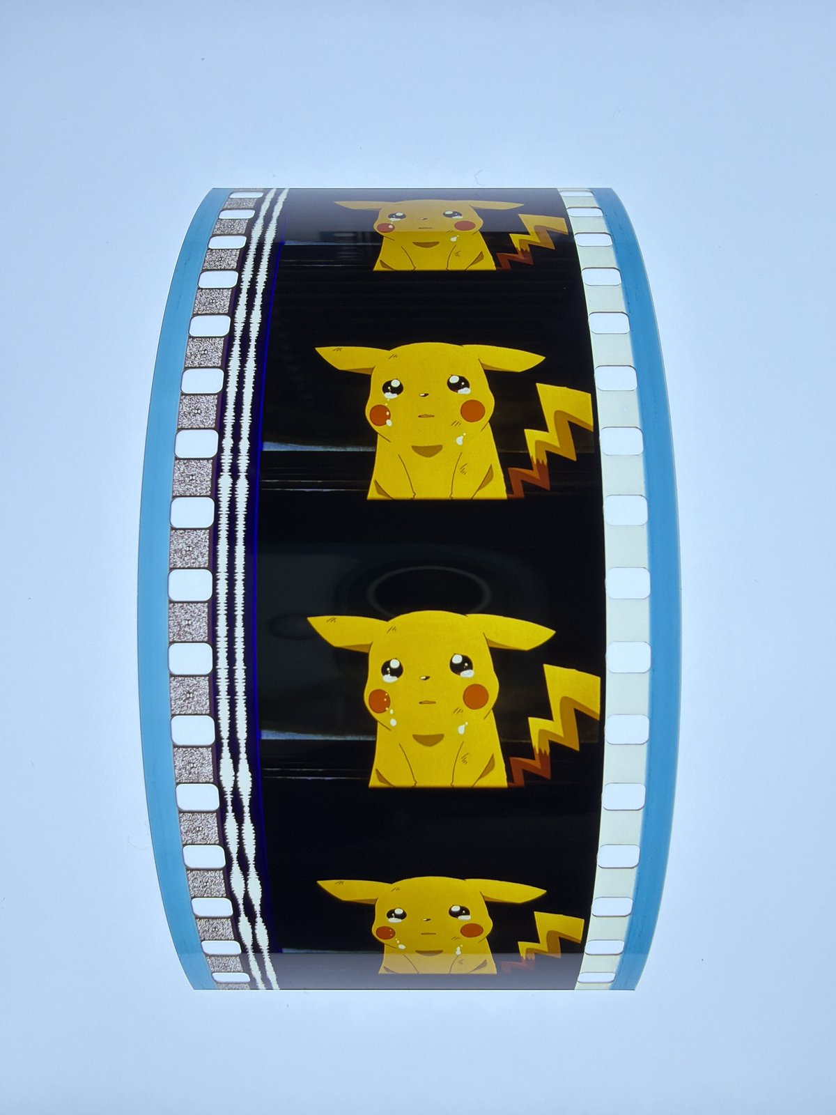 The film strip as photographed on the light panel at intake, before encapsulation