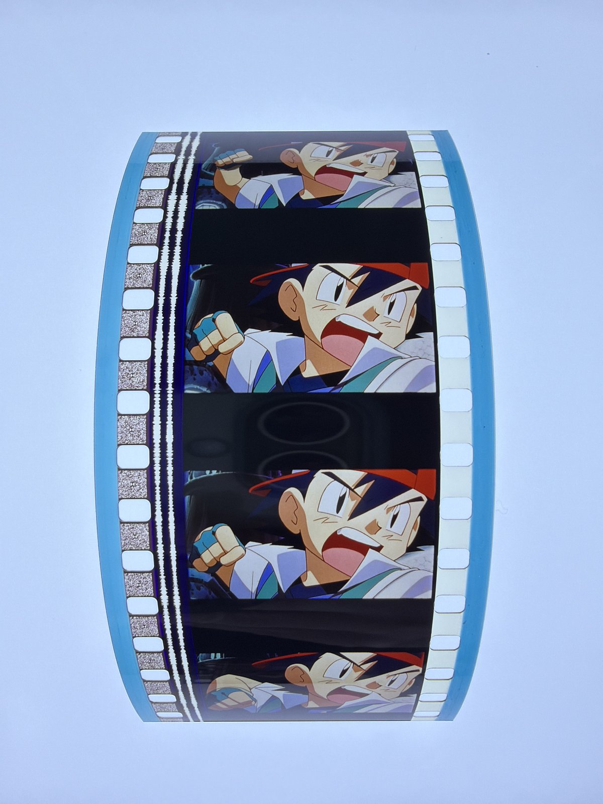 The film strip as photographed on the light panel at intake, before encapsulation