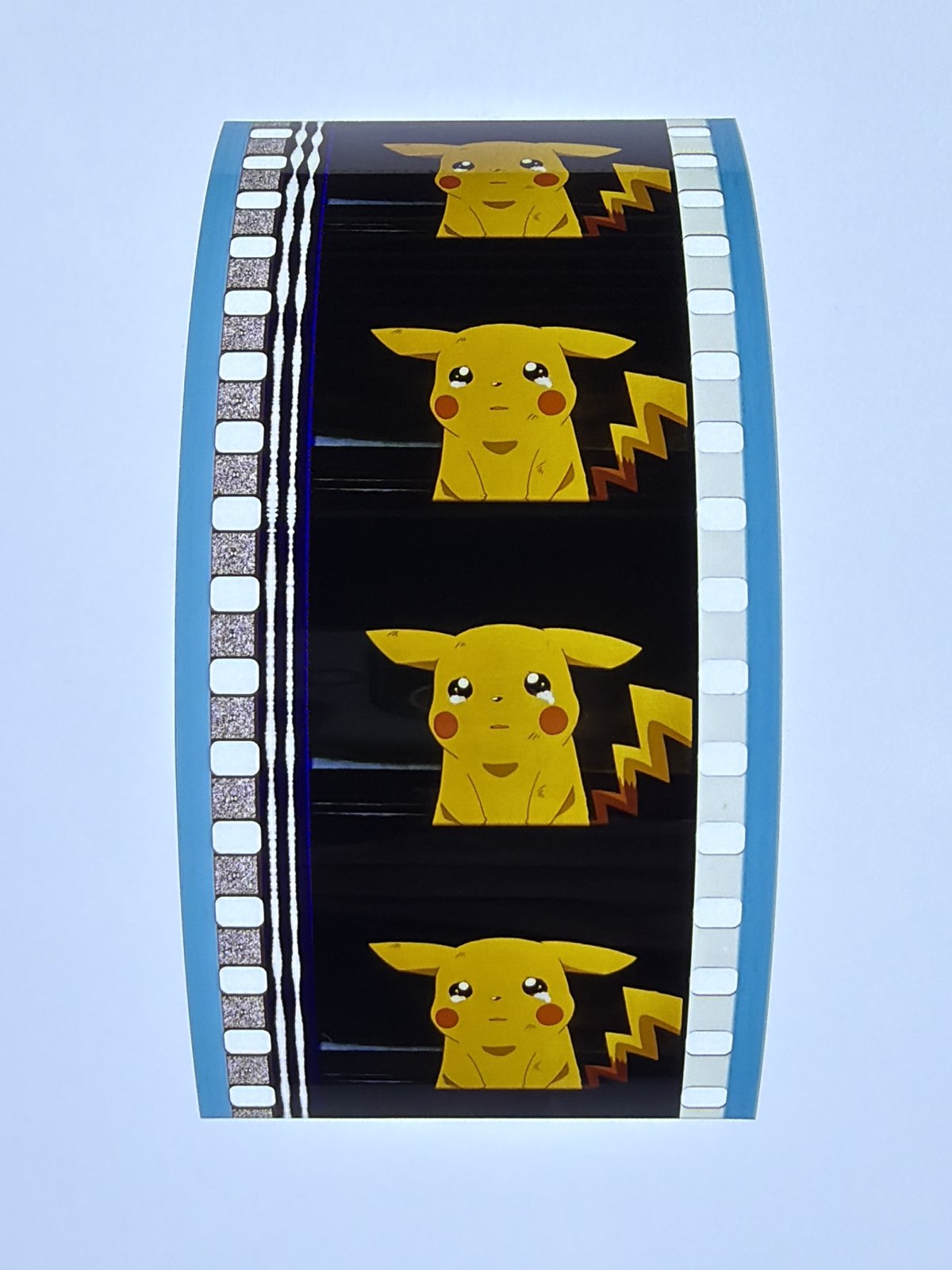 The film strip as photographed on the light panel at intake, before encapsulation