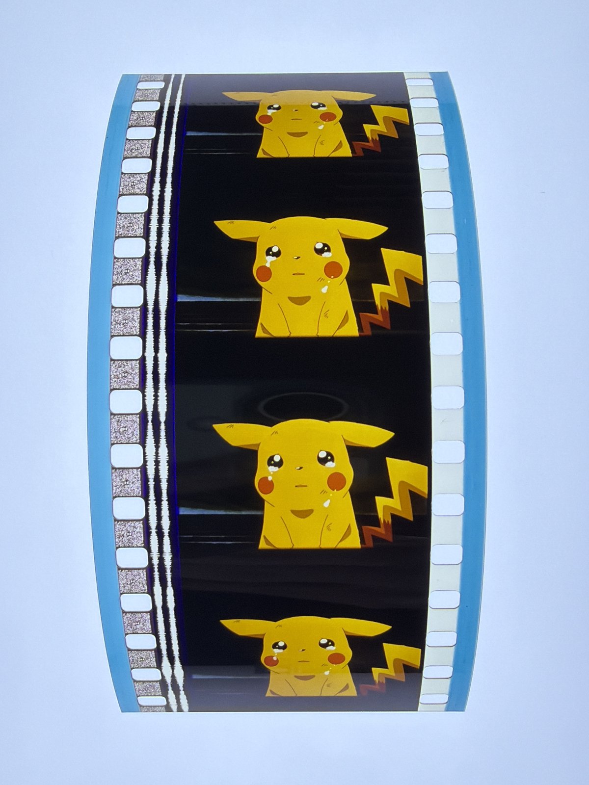 The film strip as photographed on the light panel at intake, before encapsulation
